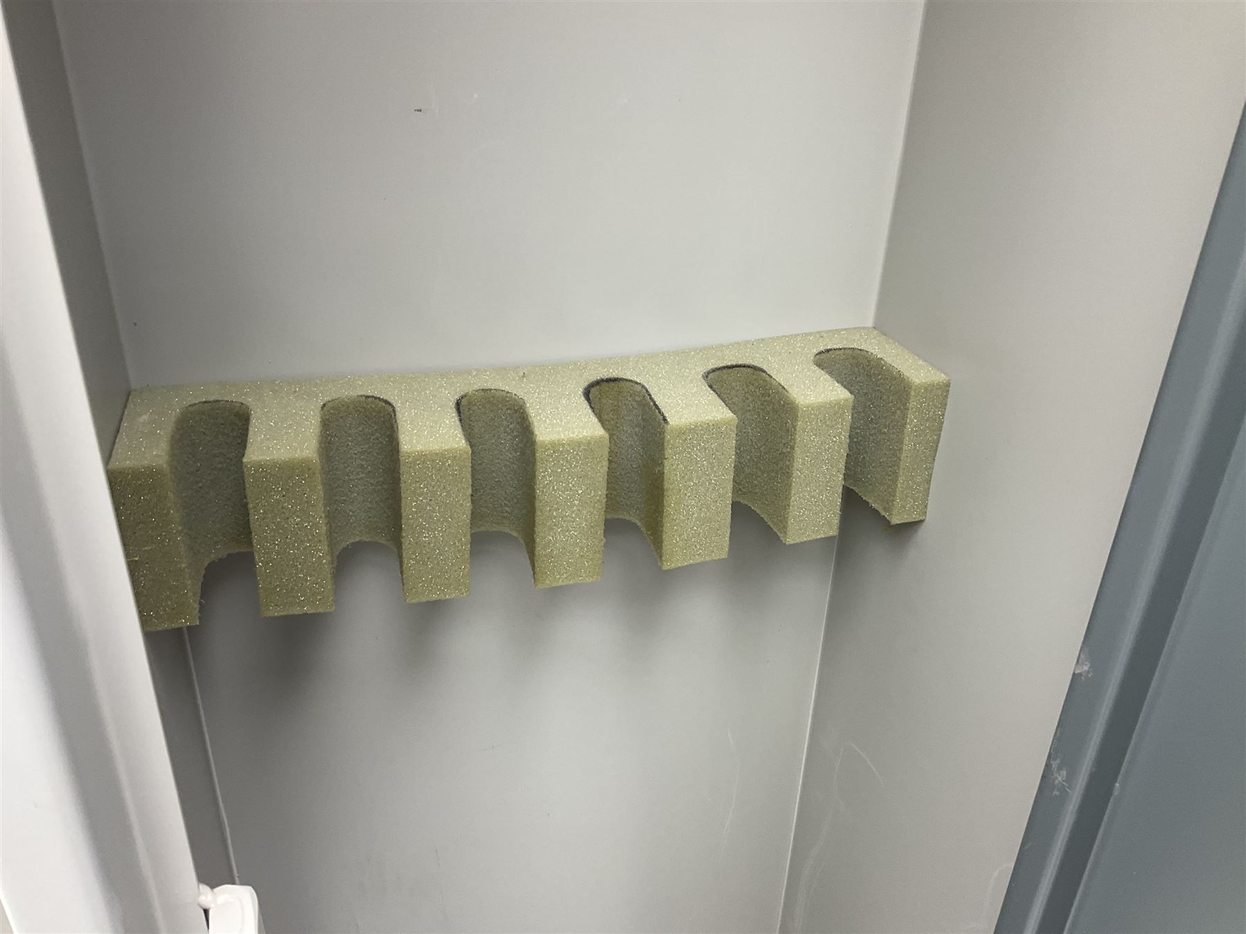 Two-tone grey steel wall-mounting gun cabinet by Sambell Engineering to accommodate six guns with fixed shelf over, gun space int. H132cm W36.5cm D23.5cm, the single double-locking door with two sets of keys, ext. H154cm W37cm D27cm