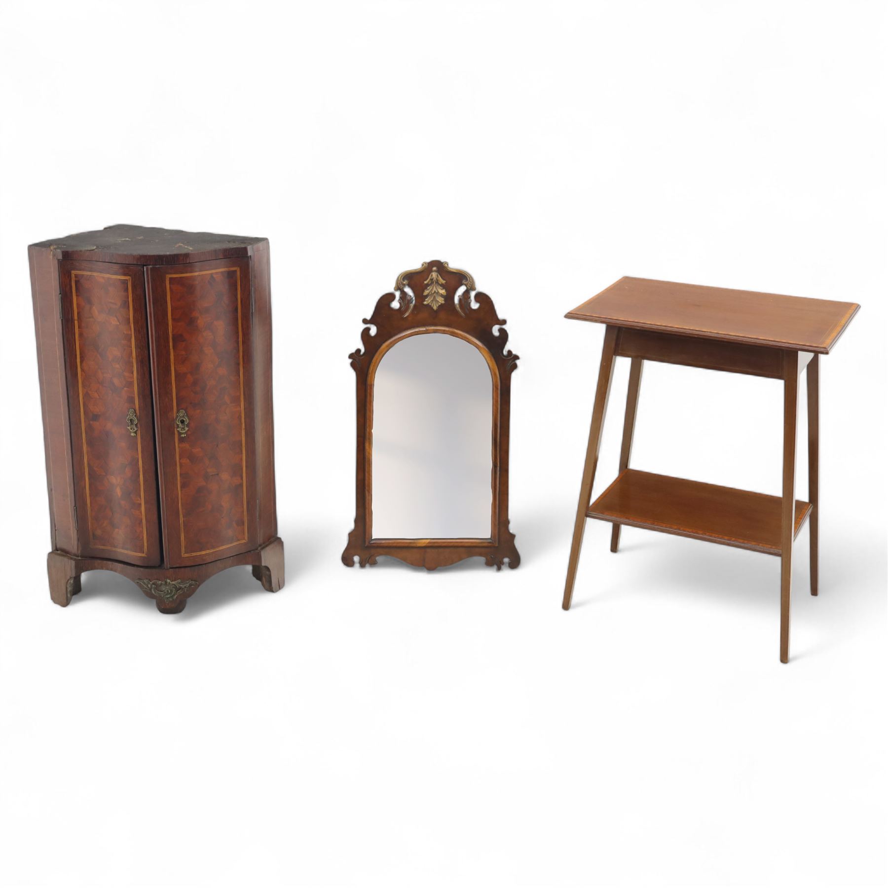 Three-piece mixed furniture lot, comprising an Edwardian mahogany occasional table with inlaid border and under-tier (H 70cm, W 54cm, D 38cm), a French parquetry corner cabinet with ormolu mounts (H 83cm, W 50cm, D 29cm), and a shaped walnut framed wall mirror with scroll cresting (H 75cm, W 43cm)