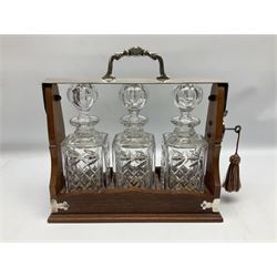 Edwardian silver plate mounted oak tantalus, containing three square sided cut glass decanters, complete with key, H33cm