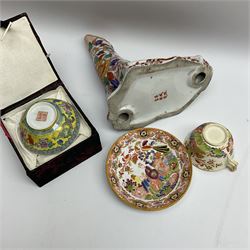 Oriental ceramics comprising a figure of a sea lion decorated with floral pattern with character mark beneath, bowl in fabric box, and cup and saucer