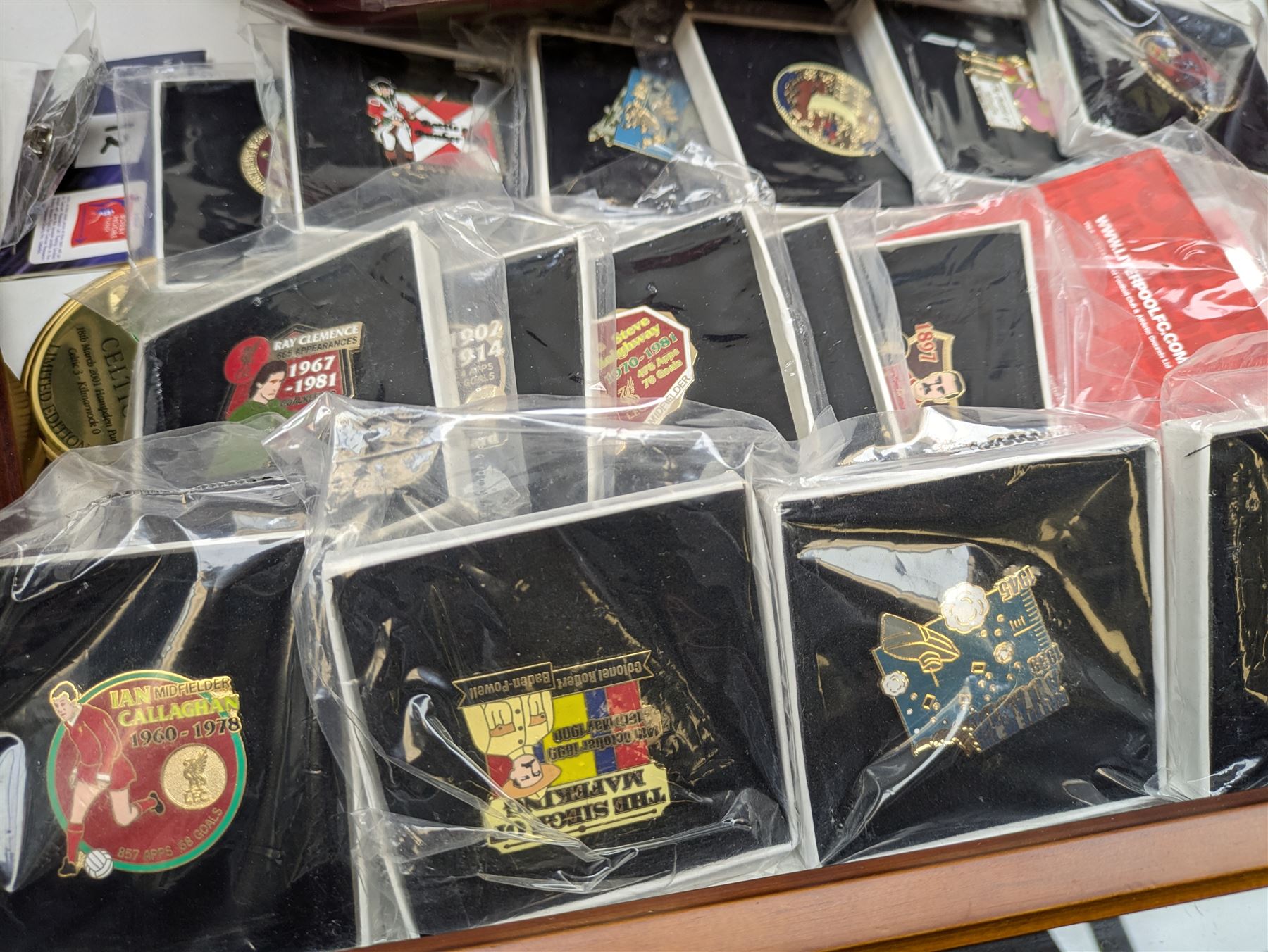 Mostly collectable pin badges and memorabilia, including various L.F.C (Liverpool Football Club) badges produced by the Danbury Mint, various ingots from the 'Golden Games' collection, 'The Battle of Minden', 'The Battle of Waterloo' and other similar pin badges, various display cases, 'Welcome to Paradise' Celtic Park laser crystal numbered 965 and other collectables