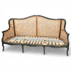Early 20th century French bergère settee, the shaped caned back flanked by caned sides and...
