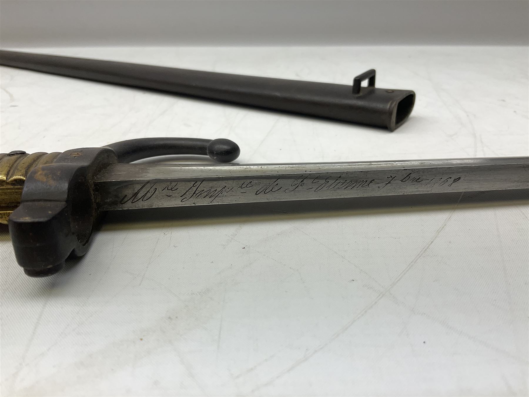 French model 1866 sabre bayonet, the 57.5cm curving blade marked St. Etienne 1868; in associated steel scabbard L71cm overall