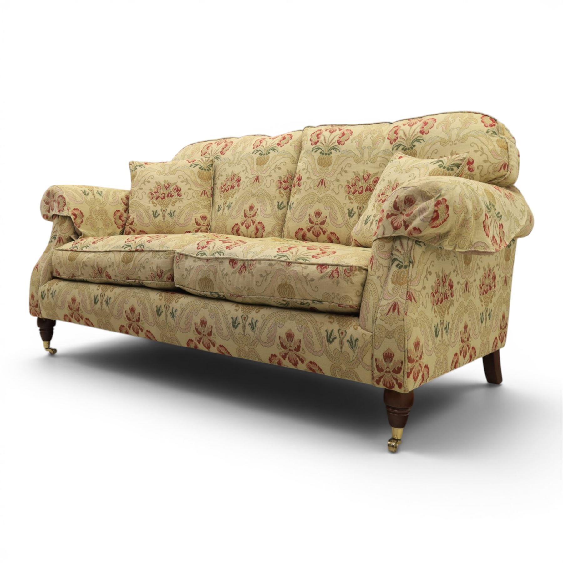 Parker Knoll - 'Henley' floral fabric living room suite, comprising a two seat sofa and pair of armchairs, raised on dark stained turned feet raised on brass castors

Armchairs (H 99cm, W 95cm, D 100cm)