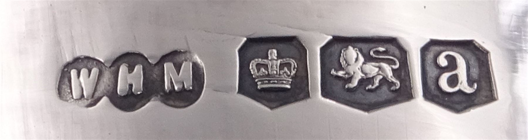 Early 20th century silver three piece tea service, comprising teapot, twin handled sucrier, and milk jug, each of oval part fluted form, the teapot with ebonised handle and finial, hallmarked Sheffield 1918, maker's mark WHM