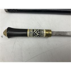 Late 19th/early 20th century Anglo Indian ebony and bone sword stick with 62cm steel blade, brass locking ferrule and lion mask pommel L92 cm.