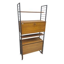 Staples Ladderax - mid-20th century teak and metal framed modular wall unit, fitted with central fall-front cupboard enclosing correspondence dividers, over secondary separate teak fall-front cupboard, adjustable shelf to top