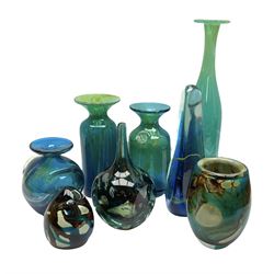 Quantity of M’dina art glass to include a streaked blue and green bottle form vase with captured bubble design and slender neck, H35cm, along with a paperweight, ovoid form vase and another vase all decorated in a blue, brown and white colour way, other contemporary glass examples etc with etched marks beneath