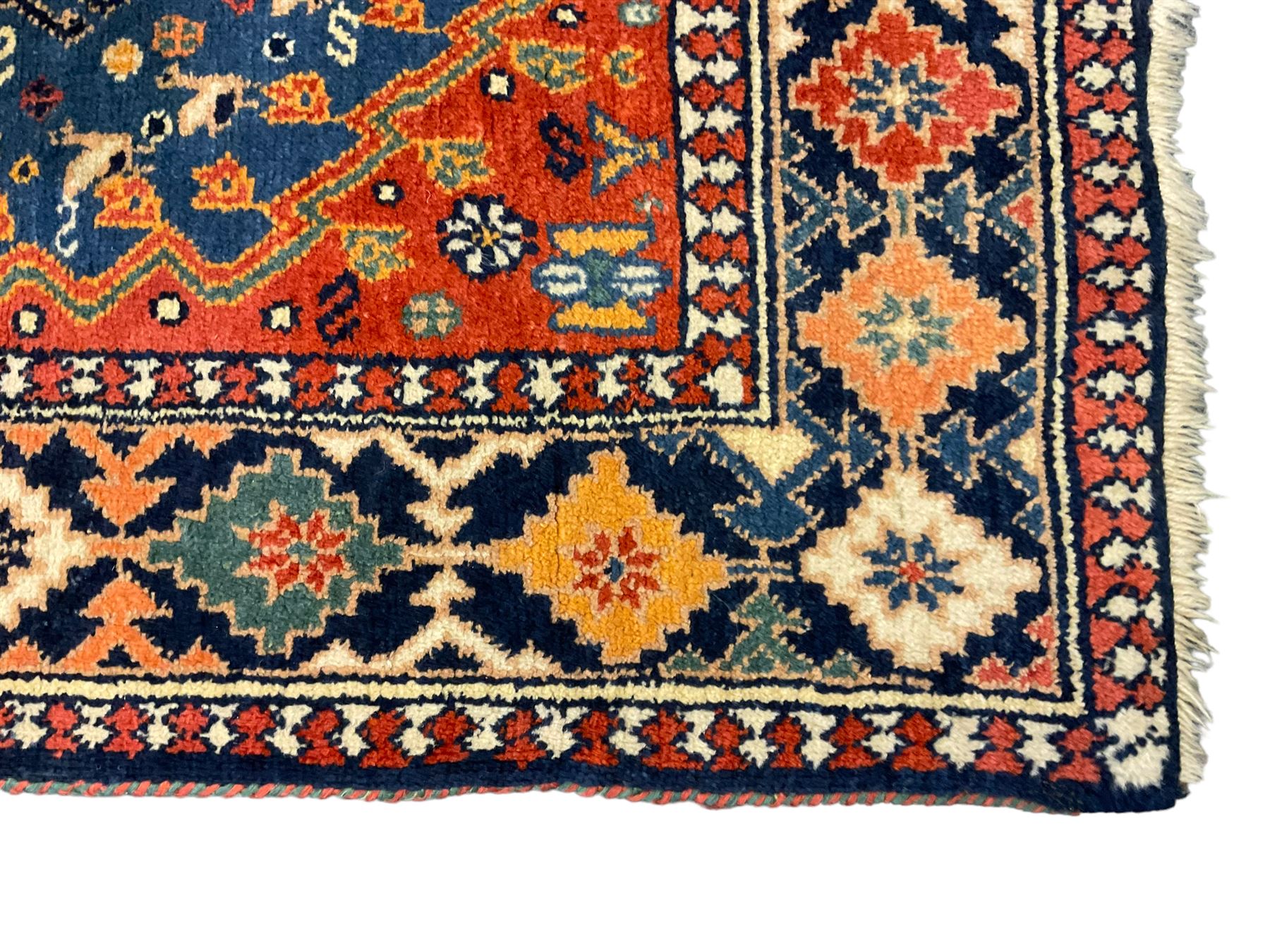 Persian blue ground rug, field decorated with four pole medallions with surrounding repeating bird motifs, coral spandrels with flowerheads, guarded border decorated with repeating geometric lozenges