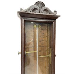 English - oak cased late 19th century Admiral Fitzroy mercury barometer, fully glazed case with a carved crested top, full length charts with detailed Fitzroy remarks and predictions, with a mercury thermometer and sliding brass indicators.