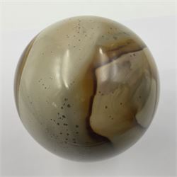 Polychrome jasper specimen egg, in creams, browns and earthy tones, upon a wooden stand, H12cm