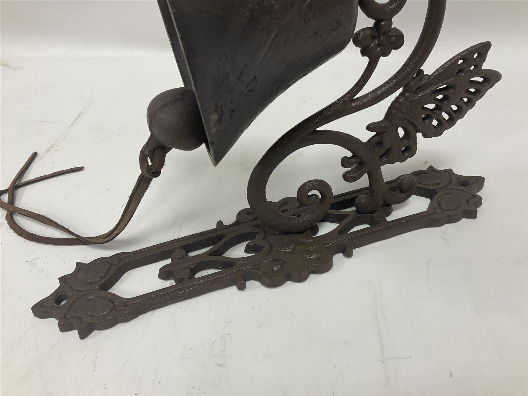Cast iron exterior hanging garden bell with decorative butterfly bracket