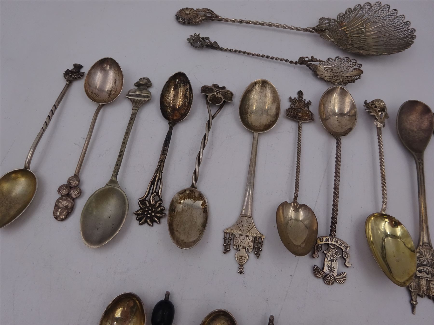 Set of six 1920s silver coffee bean spoons, together with a collection of silver souvenir and similar spoons, including two filigree examples, all tested or hallmarked