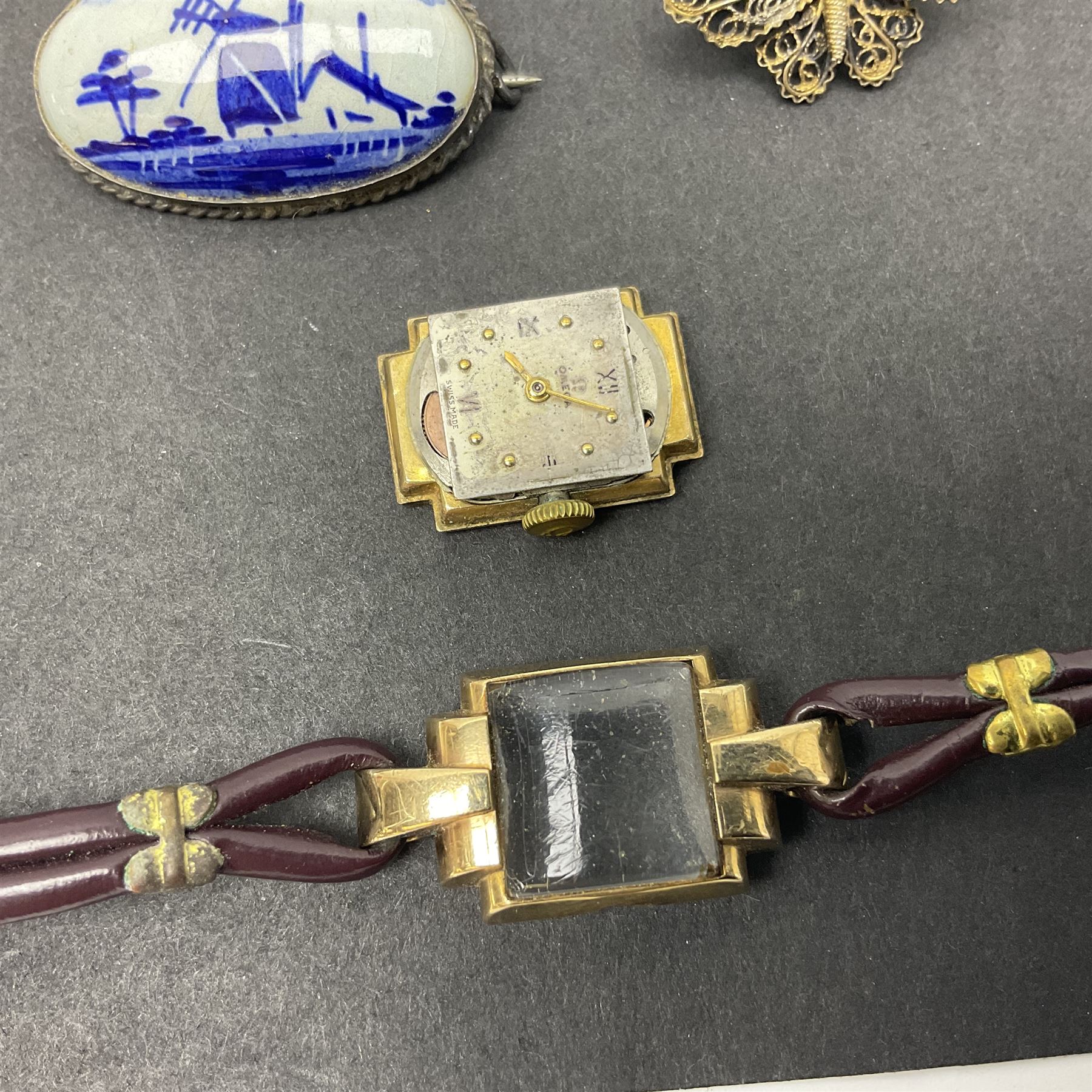 9ct gold jewellery including leaf brooch, wishbone Mizpah brooch, carnelian brooch, gold cased ladies Omega wristwatch, on leather strap and gold cased ladies Tissot wristwatch on expanding gilt strap, together with silver brooches and a Czech paste buckle, etc