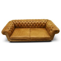 Distinctive Chesterfields - traditional shape four seater Chesterfield sofa, the rolled back and arms upholstered in deep-buttoned tan leather with matching loose seat cushions, raised on six turned supprorts