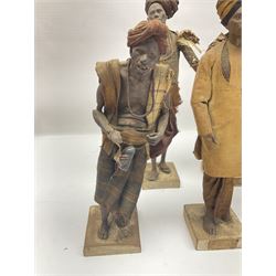 Eight 19th Century Indian clay dolls, possibly Krishnanagar, each figure with painted details, wearing cloth garments, standing on rectangular bases, some with paper label to the base, H28cm