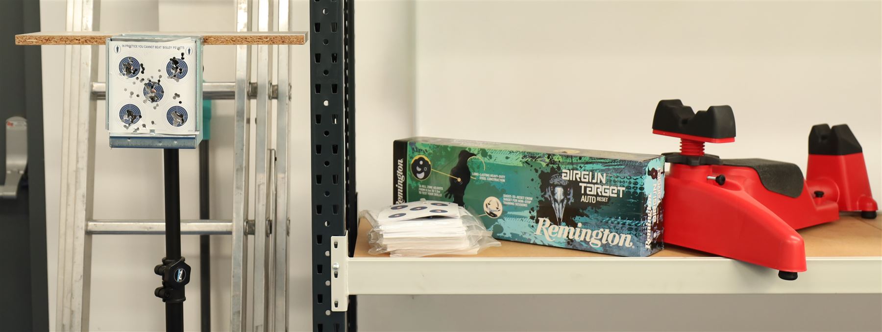 Air gun accessories; Remington Auto Reset crow target, MCM “Predator” shooting rest, paper target holder mounted to a target with additional paper targets