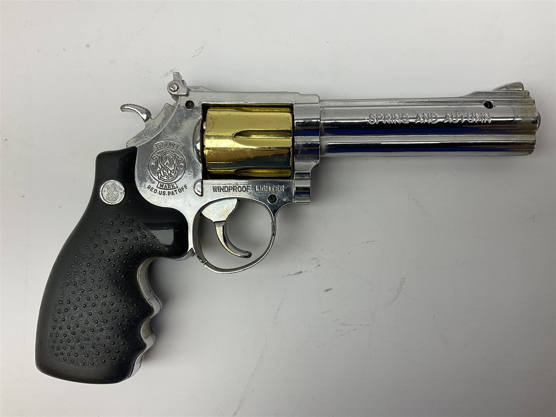 Early 20th century Flobert 5mm blank firing revolver with six-shot chamber, top venting, nickel plated with folding trigger No.118 L12.5cm overall; replica non-firing 'British Bulldog' revolver; and Windproof gas lighter inscribed 'Revolver-99 Spring and Autumn' in holster marked 'Star-Line'