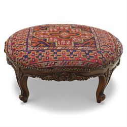 Two upholstered and caned footstools, a late Victorian carved mahogany footstool, oval form upholstered in geometric kilim-style fabric, on cabriole supports (H 27cm, W 56cm, D 47cm), together with a 20th century beech stool, square caned seat on turned supports united by stretchers (H 43cm, W 44cm, D 37cm)