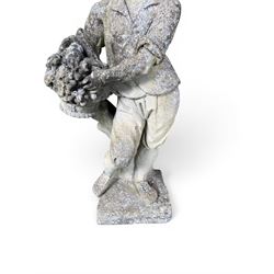 Weathered cast stone garden figure depicting a child holding a fruit basket