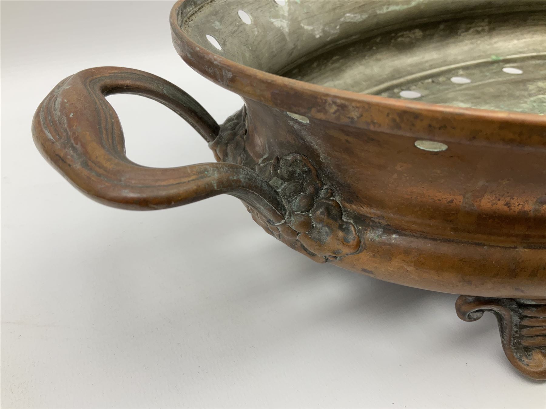 Agricultural copper corn funnel, H32.5cm, another similar copper funnel and copper warming platter of oval form, with twin handles on four supports, with removeable warming plate, L49cm