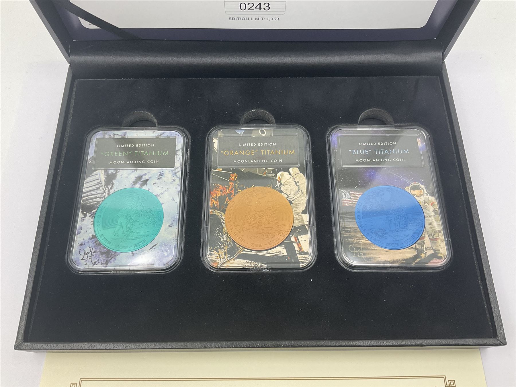 Queen Elizabeth II Bailiwick of Guernsey 2019 'The Titanium Moonlanding' fifty pence three coin set, comprising 'Green', 'Orange' and 'Blue' titanium coins, in capsules and case with certificate