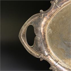 Edwardian silver twin handled tray, of navette form with C scroll decoration to the outer rim, hallmarked Goldsmiths & Silversmiths Ltd, London 1907, handle W61cm