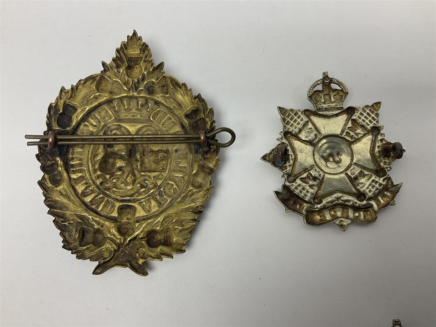 Fifteen Scottish Glengarry and other metal military badges including Argyll & Sutherland, Royal Glasgow Yeomanry, Cameronians, Lanarkshire Yeomanry, Kings Scottish Own Borderers, Highland Light Infantry, Border Regiment, Lowland Regiment, Lothians & Border Horse Yeomanry, Ayrshire Earl of Carricks Own Yeomanry etc