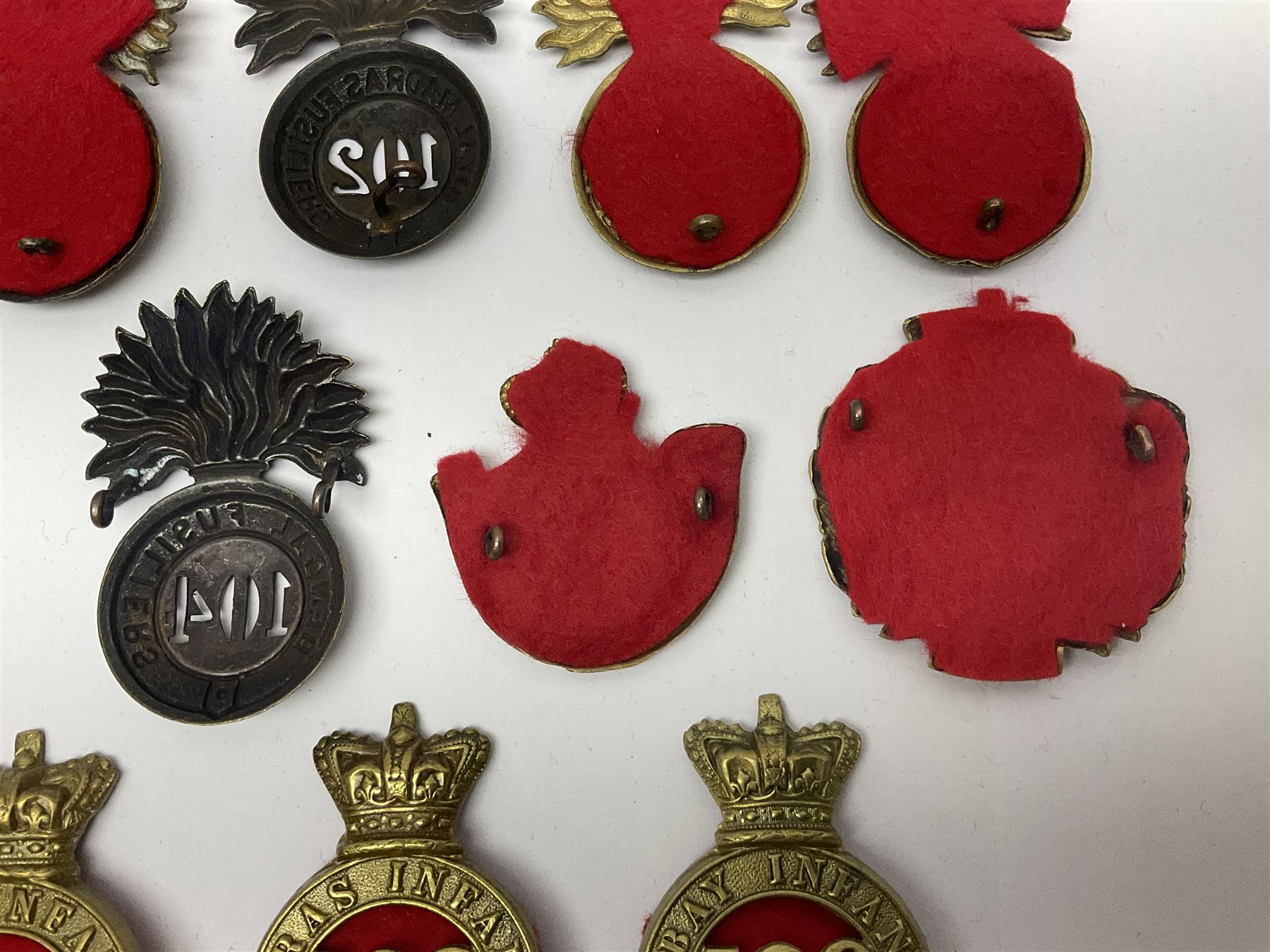 Ten cap badges of Indian interest comprising Bengal Fusiliers No.104, Bengal Infantry No.107, Royal Bengal Fusiliers No.101, Bombay Infantry No.109, Bombay L.I. No.106, two Royal Madras Fusiliers No.102, Madras Infantry No.108 and Madras L.I. No.105 (10)
