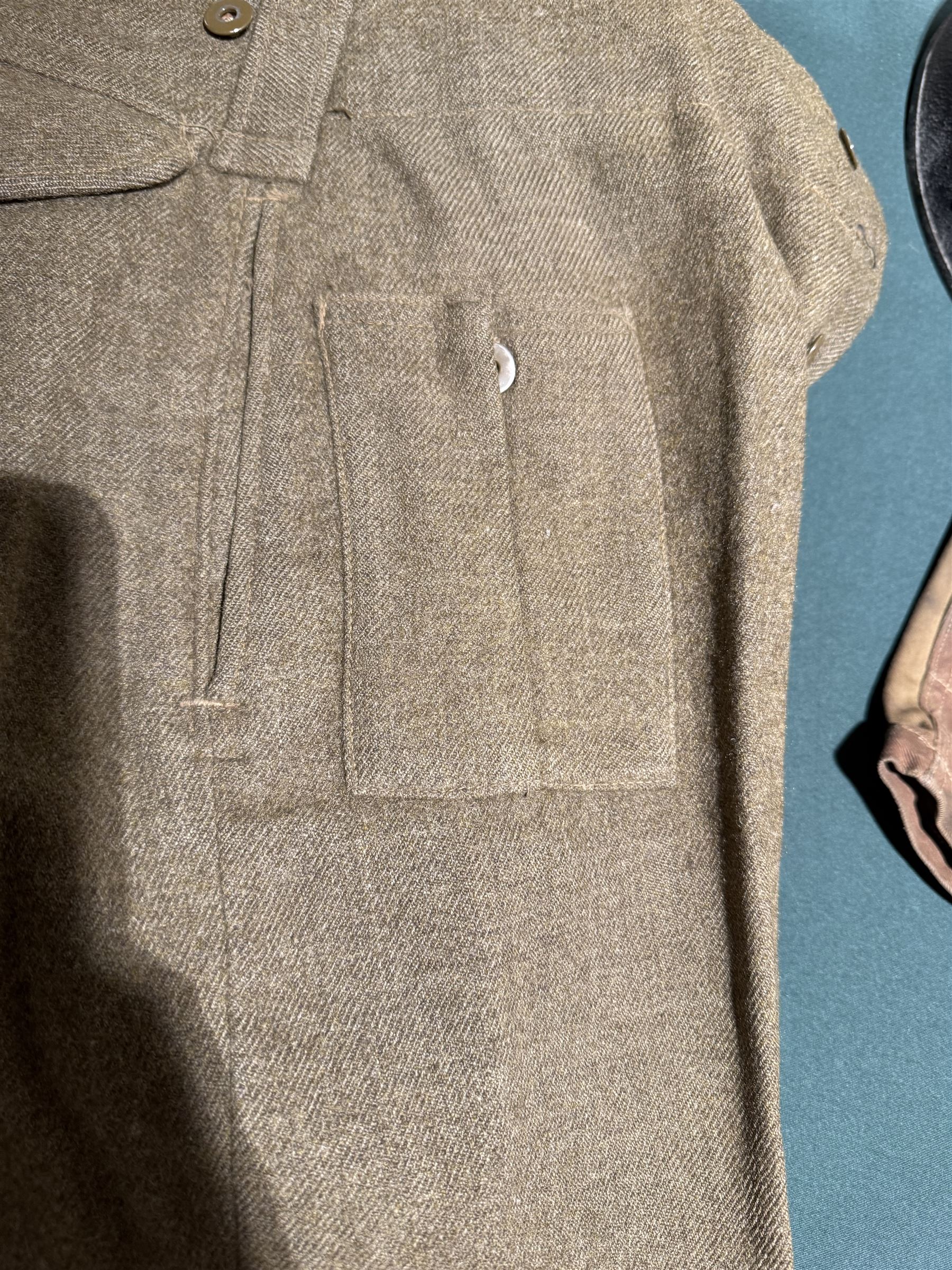 WWII British parachute regiment battle dress uniform, the jacket with shoulder title and Pegasus formation badge to the left arm, shoulder title, Pegasus formation badge and cloth wings to the right, size 3 dated 1943, the trousers size 3 dated 1945 