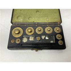 Set of laboratory balance scales by Reynolds & Branson of Leeds in fully glazed mahogany case with rise-and-fall front door, black vitrolite base with brass feet and hand cranked action L40cm H51.5cm D30cm; and bakelite cased set of brass weights