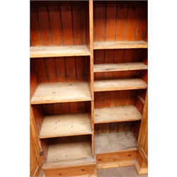  Early 20th century breakfront pitch pine triple cupboard, projecting cornice, three doors enclosing shelves on plinth base, W163cm, H170cm, D44cm  