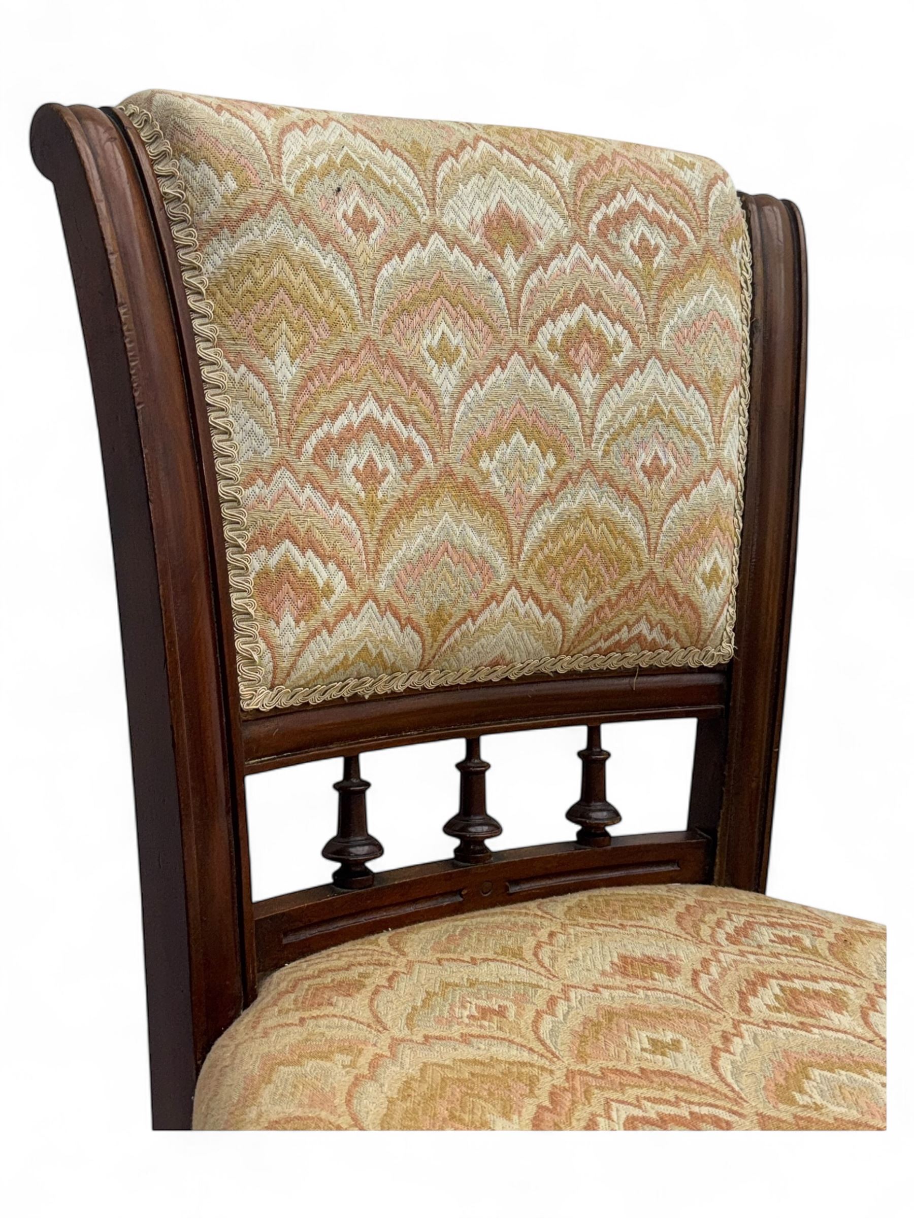 Victorian mahogany centre table, circular top above turned pedestal, terminating on three cabriole legs with scroll feet on porcelain castors, and six scroll carved upholstered dining chairs, with cushion and spindle turned backs, centre table  118x74cm, dining chairs 89x46x50cm