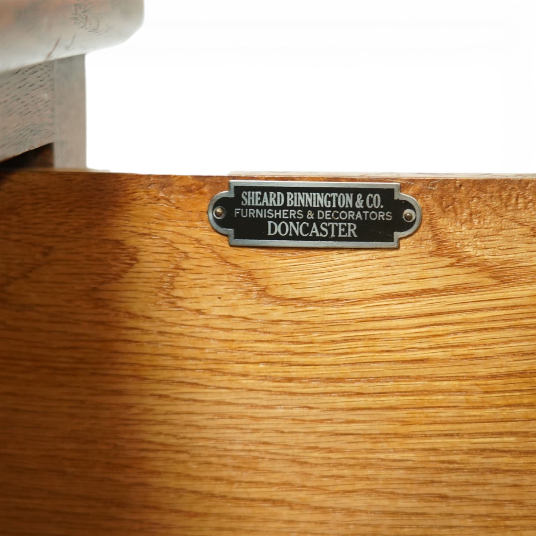 Mid 20th century oak chest of drawers, rectangular top with gently rounded front edge over four graduating drawers fitted with recessed ribbed wooden handles, plain drawer fronts, raised on an integral plinth base