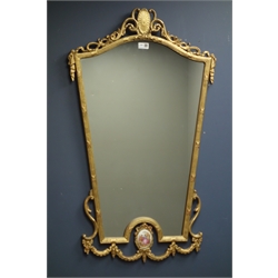  Wall mirror in gilt scroll work frame with oval Serves style porcelain inset, 59cm x 97cm   
