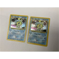 Collection of Pokemon trading cards, mostly 1999 Wizards Pokemon cards to include holo Charizard 4/102, first edition holo Machamp 8/102, further holographic cards; Dark Flareon 35/82 and Dark Vaporeon 45/82, cards from themed sets and 4th edition prints; 1998 Electronic Pokédex with cardboard boxes for themed decks Blackout, Overgrowth and Power Reserve Jungle, along with a large quantity of energy and trainer cards 