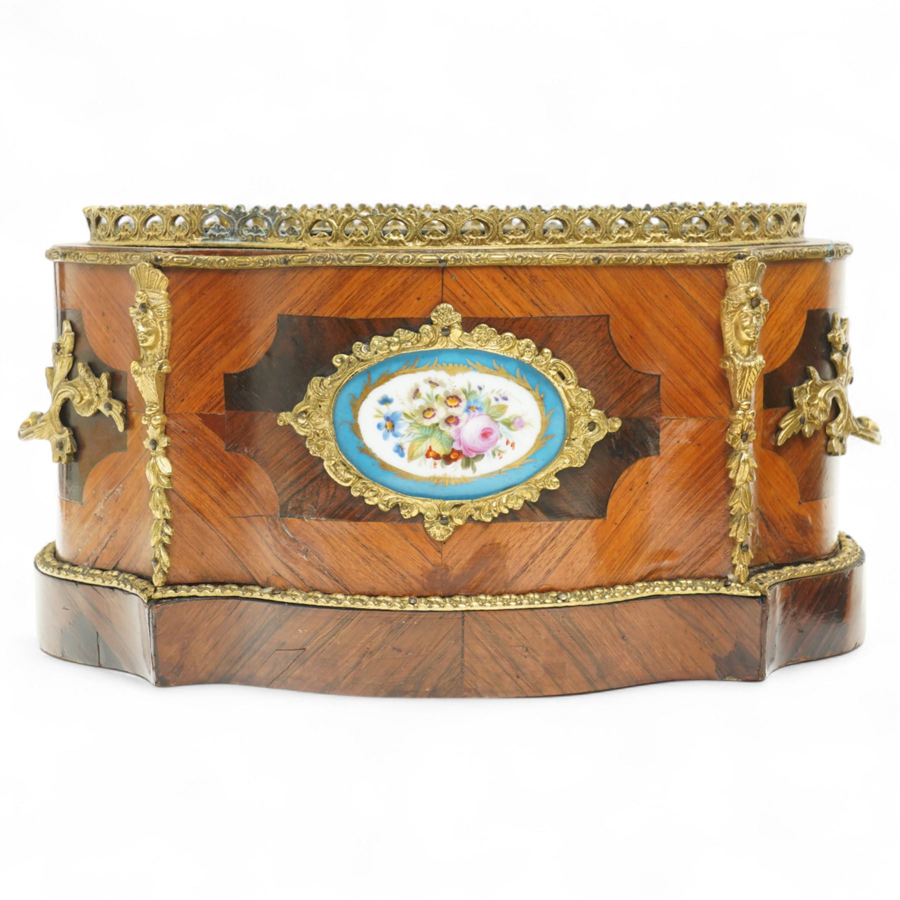 Matched pair of 19th-century French Kingwood and gilt brass mounted table jardinières, quatrefoil-shaped form with original zinc liners, foliate gilt brass mounted pierced gallery above kingwood crossbanded sides and inset serves style porcelain plaque and gilt brass carrying handles on plinth base