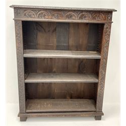 Victorian heavily carved oak bookcase, rectangular top with carved and moulded edge, flower head lunette frieze, three adjustable shelves