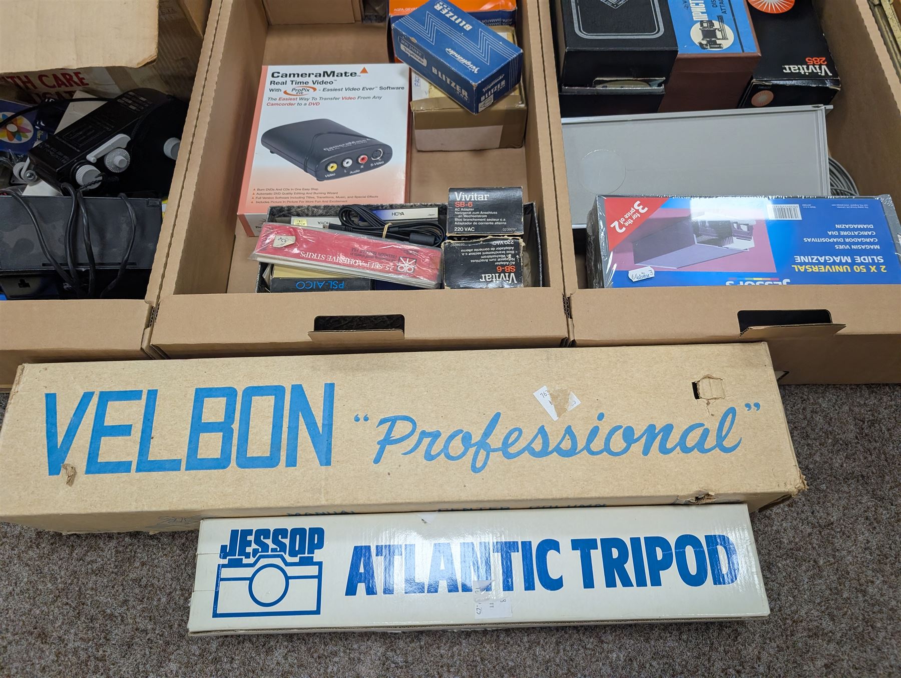 Large collection of photography equipment, including two video cameras JVC and a Panasonic 3CCD, tripods, filters, photograph paper, developing equipment, Dalite projector screen, etc, some boxed some empty boxes, and a Midgard Pocket Microscope
