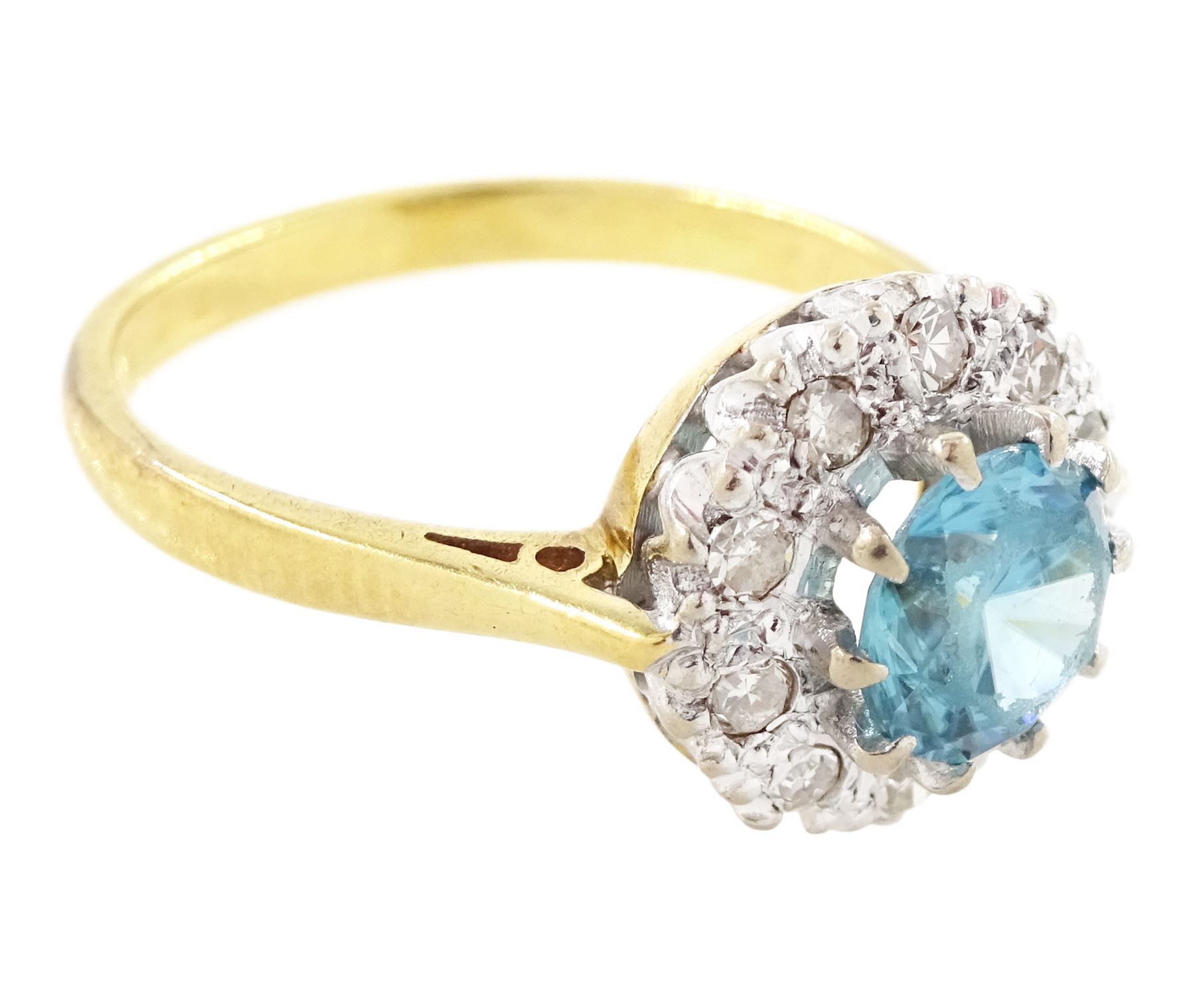18ct gold blue zircon and diamond cluster ring, single round cut blue zircon surrounded by ten single cut diamonds, London 1965