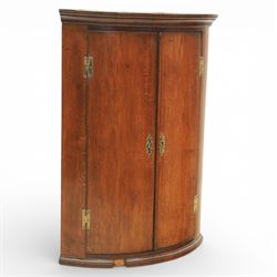 George III oak and mahogany wall hanging cylinder corner cupboard, moulded cavetto cornice...