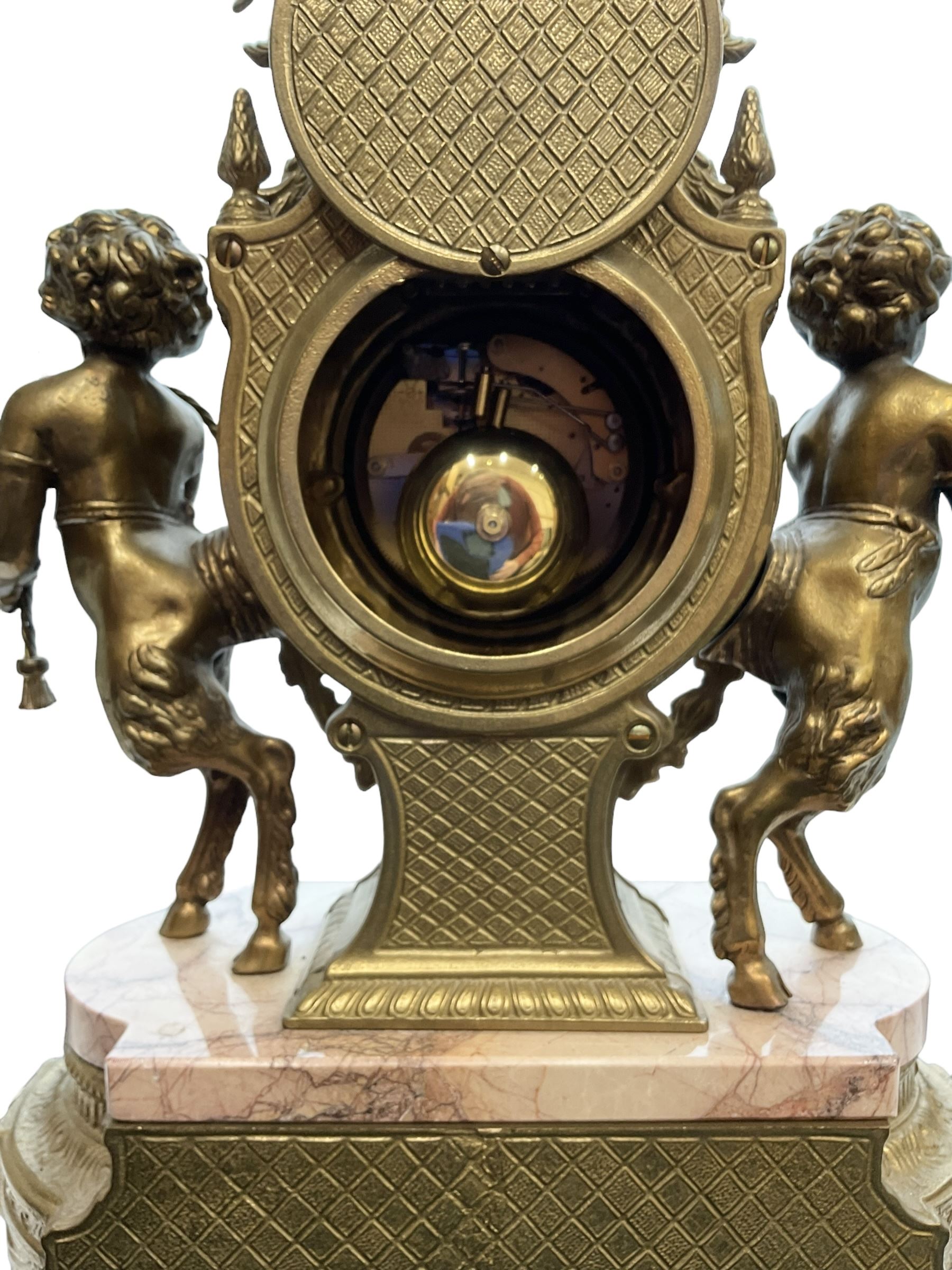 Imperial - 20th century continental 8-day brass and marble mantle clock, with an enamel dial, Roman numerals and pierced gilt hands, twin train striking movement sounding the hours and half hours on two bells, with a floating balance escapement.  With key.