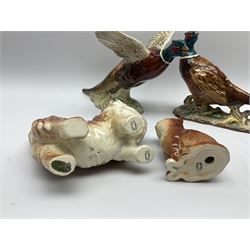 A collection of Beswick figures, comprising ginger cat model no 1898, ginger Persian kitten model no 1886, pheasant in flight model no 849, and pheasant model no 1226b.  