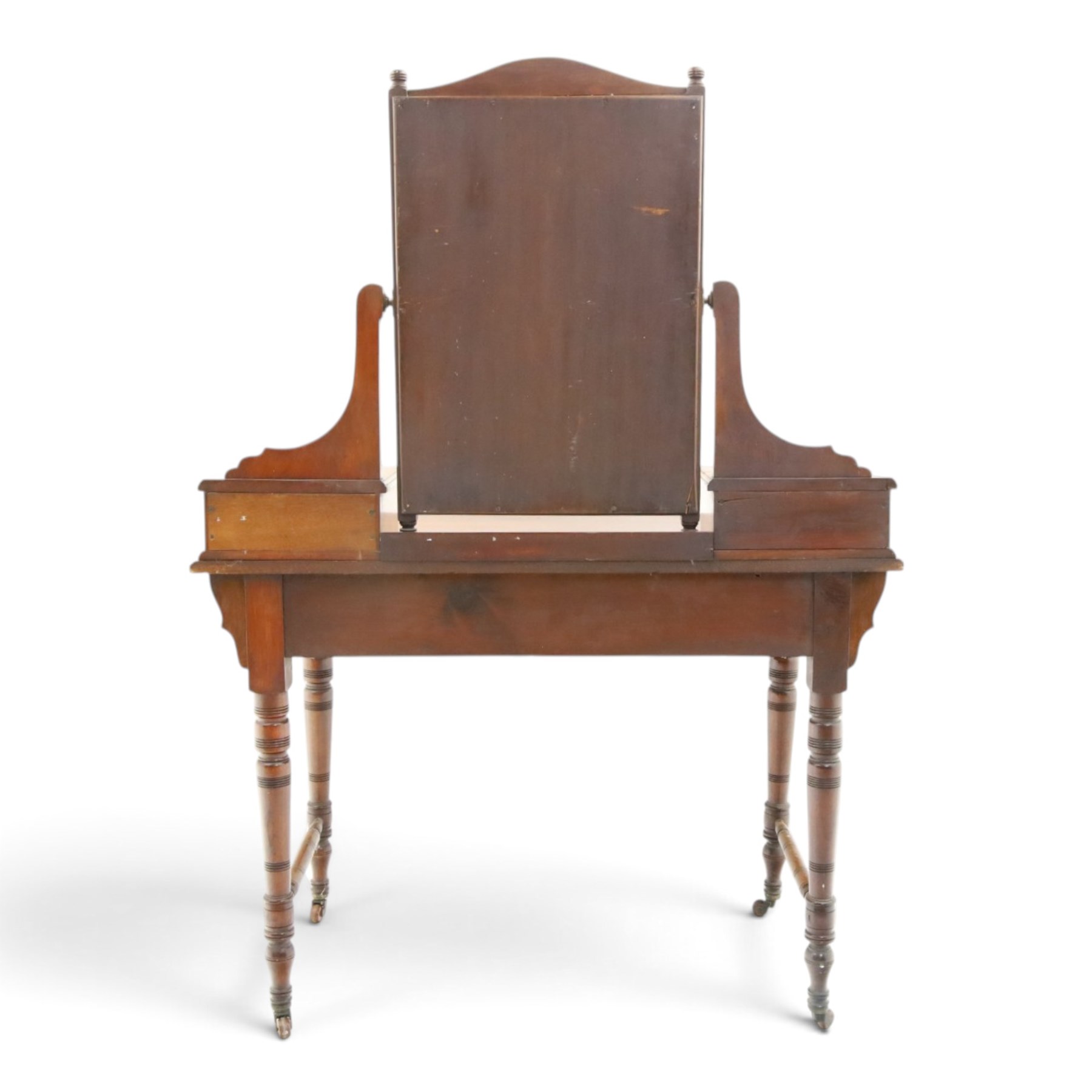 Late Victorian figured walnut and mahogany dressing table, raised swing-mirror back over trinket drawers, fitted with two drawers with brass Aesthetic Movement handles, on ring-turned supports with ceramic castors