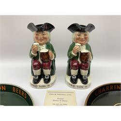Pair of Royal Doulton Toby Ale Jugs, produced in 1934 for Charrington Ales, together with two circular metal serving trays advertising Charrington brewery, a Charrington badge awarded for 25 years of service and a 1949 menu Fox & Nicholl Ltd annual dinner dance at the toby jug hotel.  