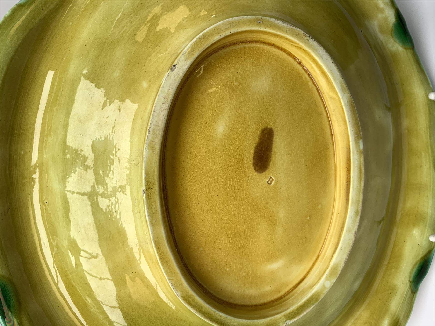 A Victorian majolica bread plate depicting corn within a woven basket, L33cm, together with a Victorian majolica jug modelled in the form of a corn cob, with registration mark beneath, H22cm. 