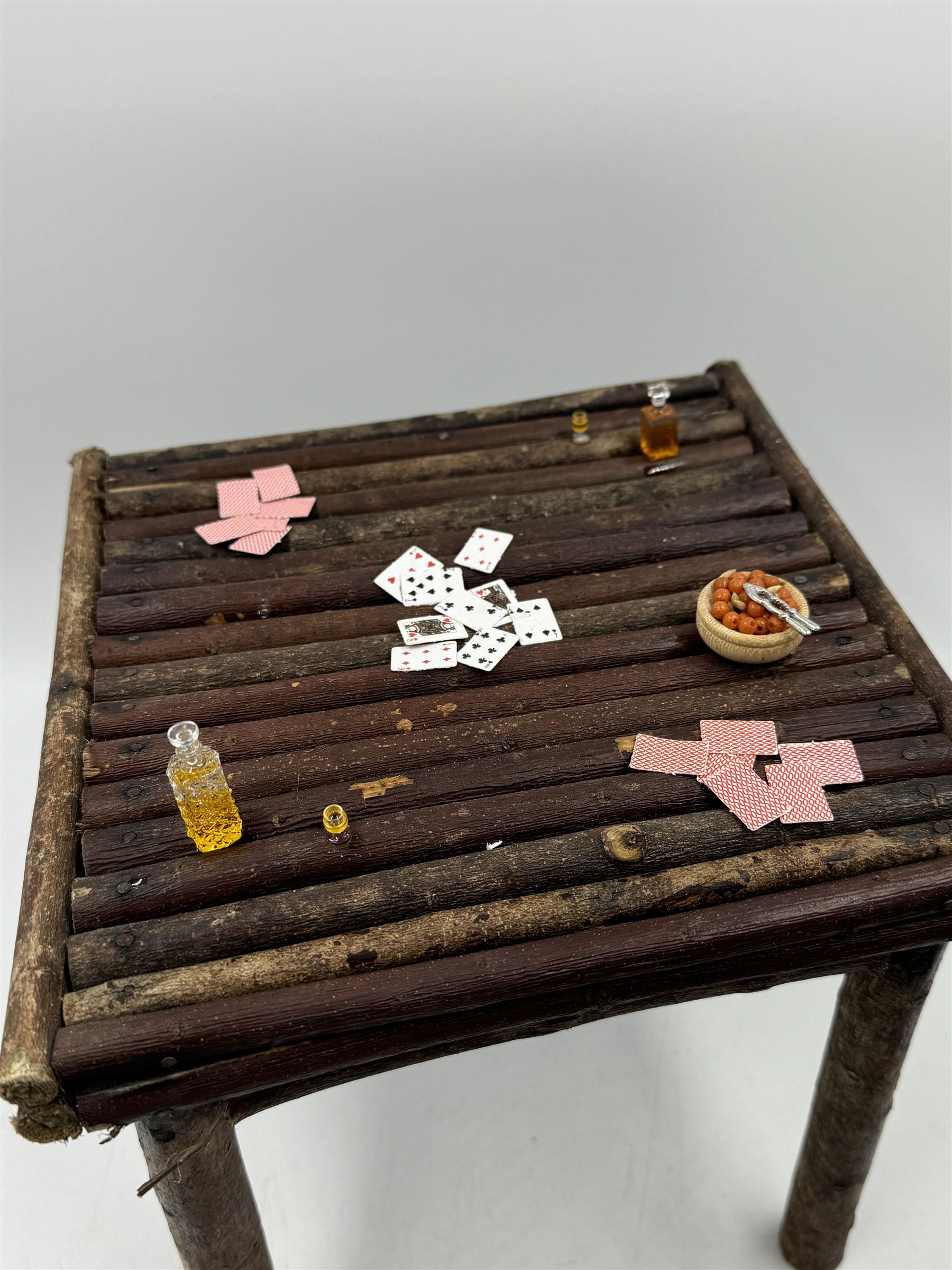 Anthropomorphic Taxidermy: Two red squirrels (Sciurus vulgaris), both seated upon a chair holding playing cards, one smoking a pipe 