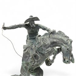 After Frederick Remington (American 1861-1909): 'Bronco Buster', limited edition bronze bearing signature and numbered 7/100, with foundry or ranch mark to horses backside of a triangle within circle, on green marble base, H56cm