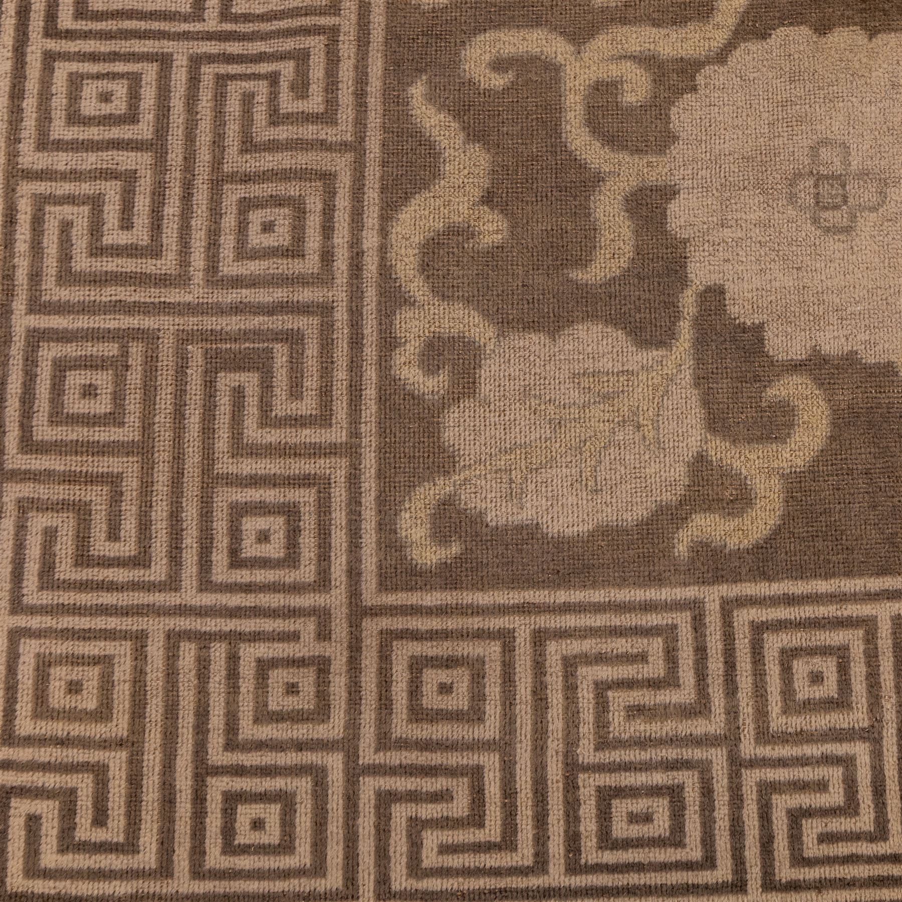 Indian Khetar hand knotted carpet, the brown ground decorated with an all over scrolling foliate and palmette design, enclosed within a conforming floral border with guard stripes