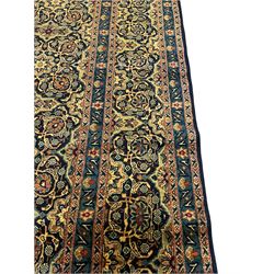 Persian Meshed golden blue ground Herati carpet, the field decorated with repeating floral Herati motifs, multi-band border decorated with scrolling foliate and flower head motifs